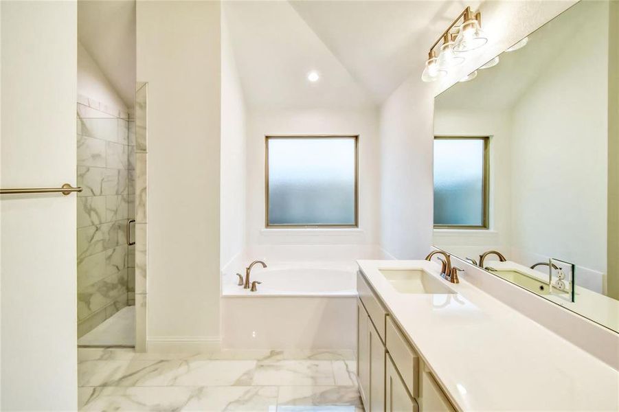 Bathroom with lofted ceiling, vanity, and plus walk in shower