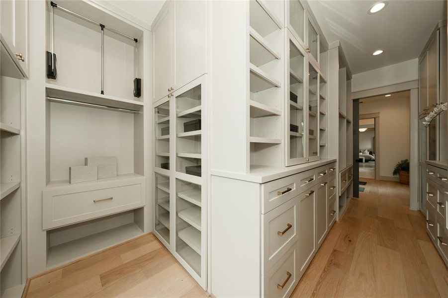 Closet equipped with pull downs, drawers and glass cabinets