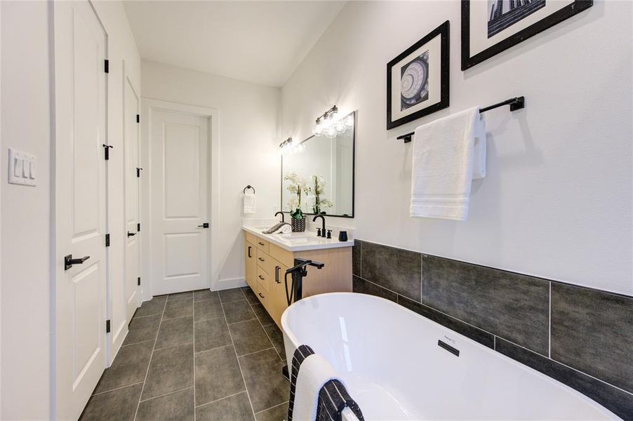 Primary Bathroom. Features soaker tub and custom tiled oversized shower with rainfall shower head.