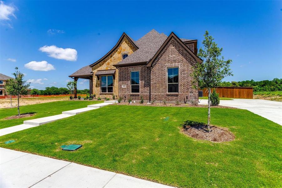 Craftsman inspired home with a front yard