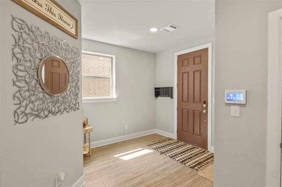 Foyer entrance featuring light hardwood / wood-style floors