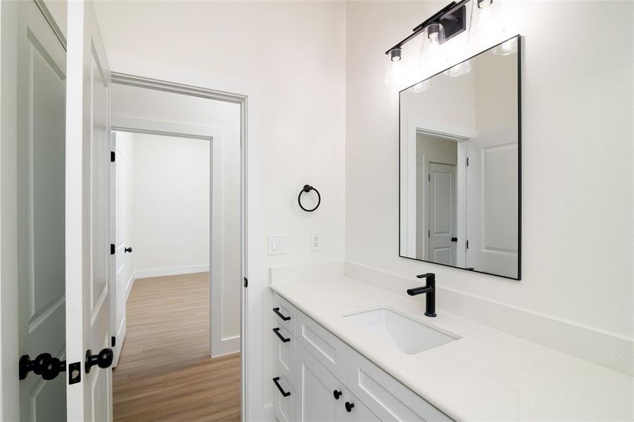 Bathroom with vanity and hardwood / wood-style floors