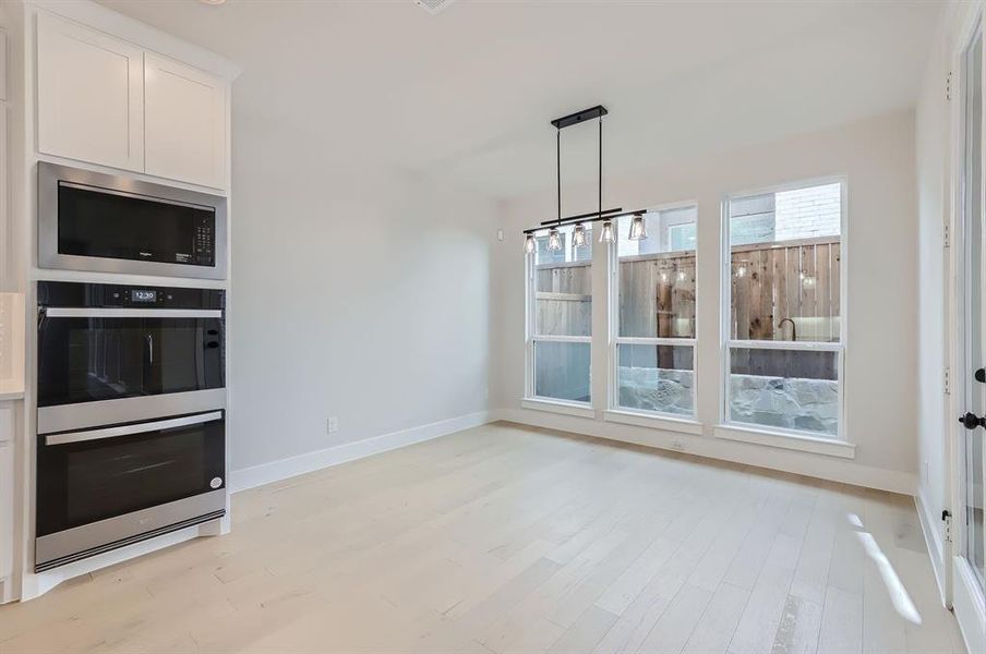 Unfurnished dining area featuring light wood-type flooring