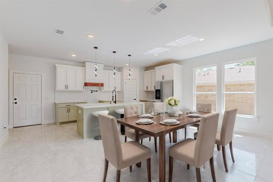 Staged Tiled dining space featuring sink