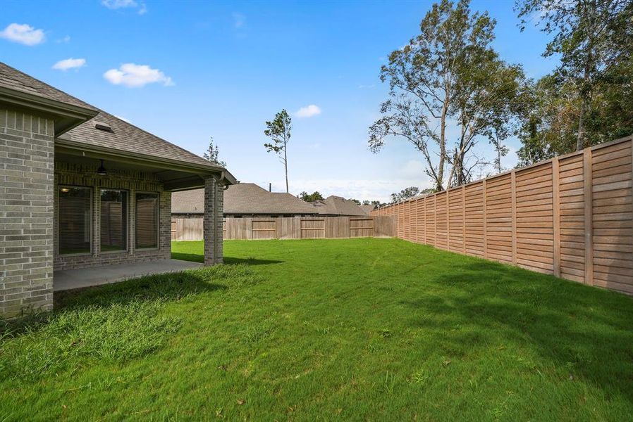 Expansive covered patio includes this outdoor tv