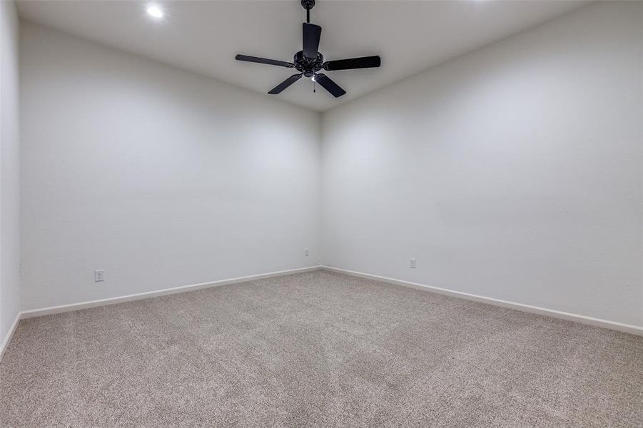 Empty room with carpet and ceiling fan