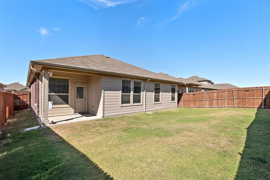 Back of house featuring a lawn