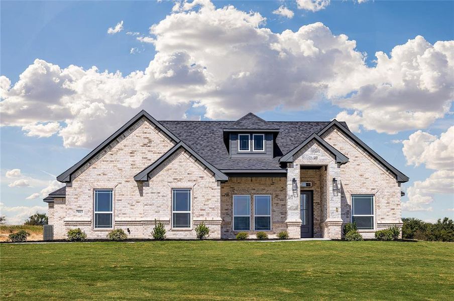 View of front of home featuring a front lawn and central AC