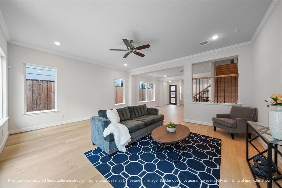 Bright and inviting, with a ceiling fan and recessed lights, the living room is the perfect spot for any activity.