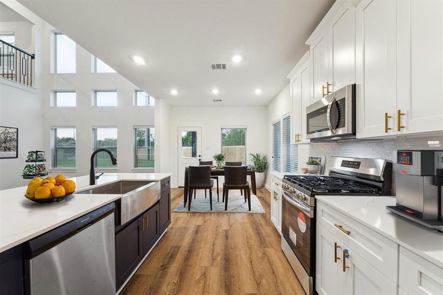 This modern kitchen with its adjacent breakfast nook offers the perfect spot to start your day. The expansive counter space and open view of the living area make it easy to stay connected with family or guests while preparing meals.