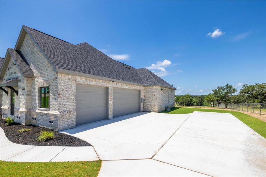 View of property exterior featuring a garage