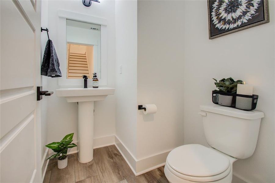 Powder room conveniently located between the second and the third floor.  Photos from another community by the same builder, FINISHES & FLOOR PLAN WILL VARY!