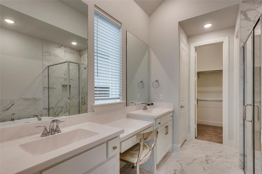 Bathroom featuring tile patterned flooring, shower with separate bathtub, and double vanity