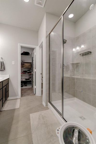 Bathroom featuring vanity, an enclosed shower, and tile patterned floors