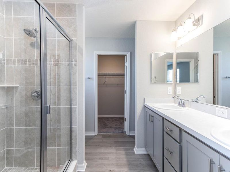 Your suite is complete with a walk-in wardrobe, linen closet, and spacious en-suite bath - Seabrooke ll home plan by Highland Homes