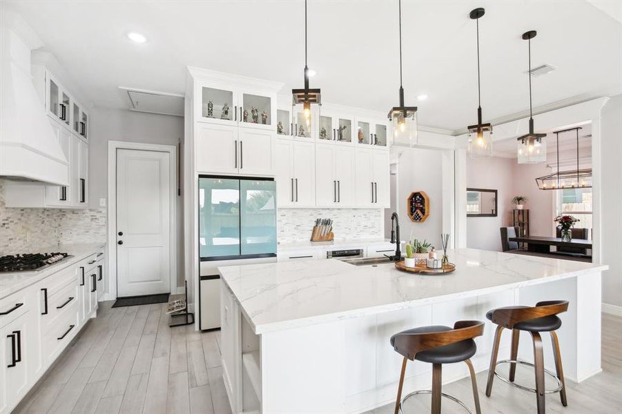 Top row of cabinets with glass and lighting