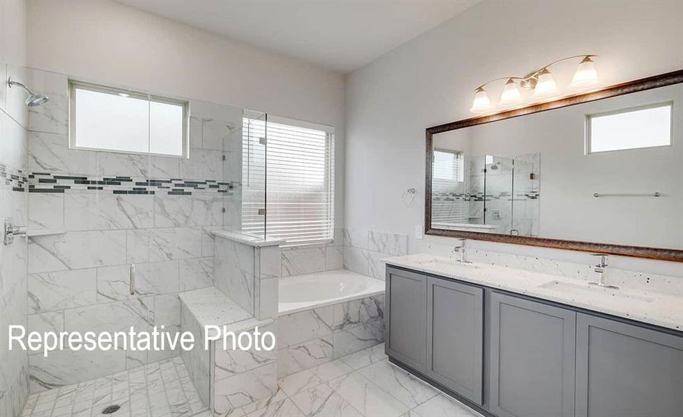 Bathroom featuring a wealth of natural light and separate shower and tub