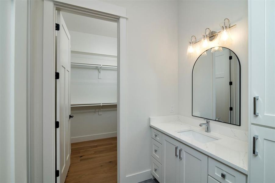 Bathroom with vanity and wood-type flooring