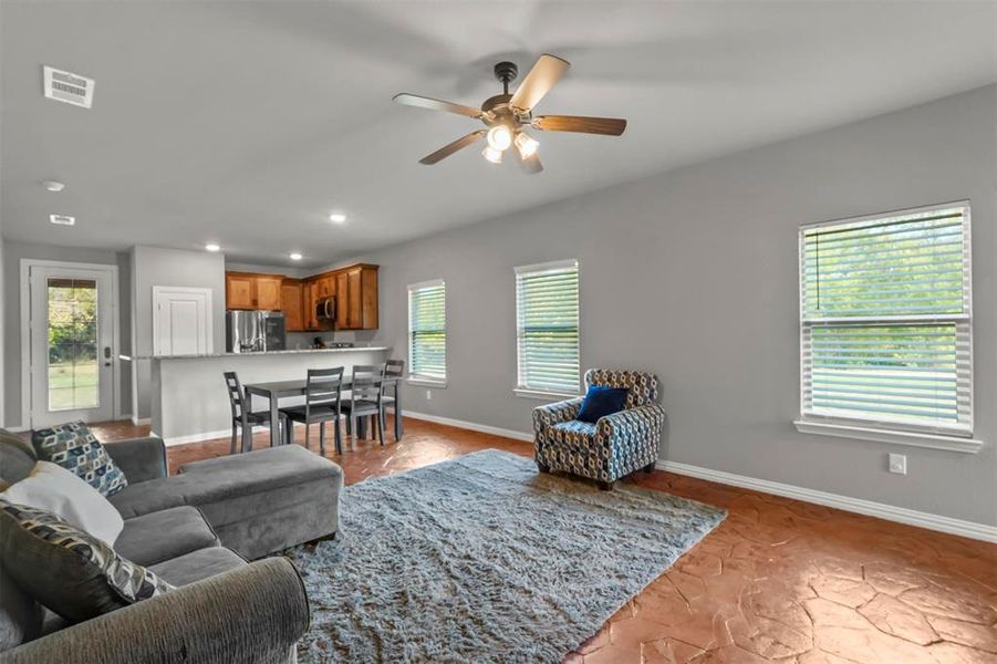 Living room, Dining, and Kitchen with view from front of home near entry