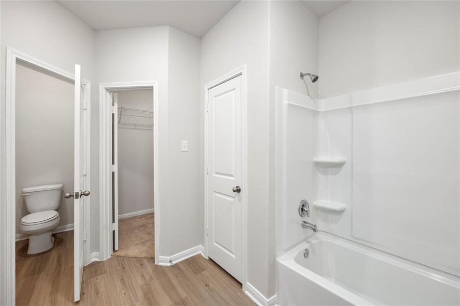 Luxurious primary bathroom with walk-in closets.