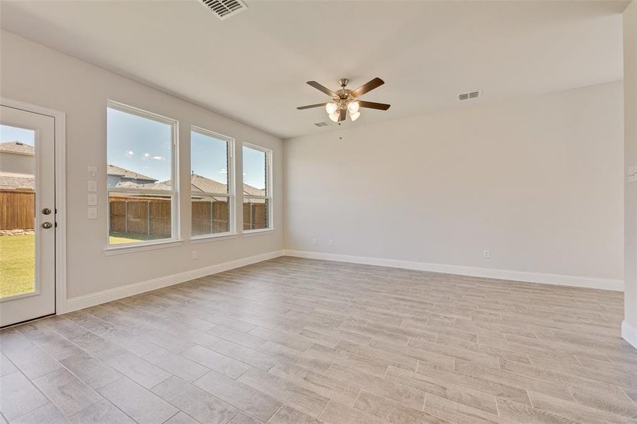 Spare room featuring ceiling fan and light hardwood / wood-style floors