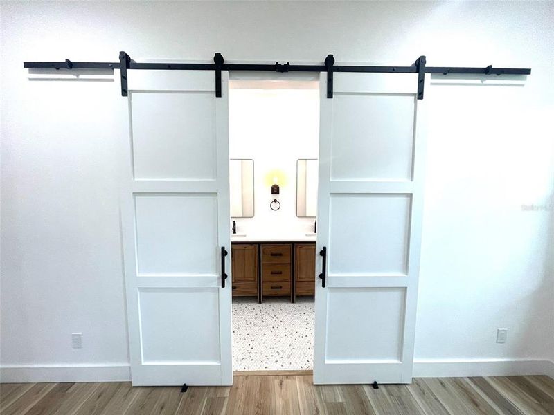 Barn doors lead to master bath