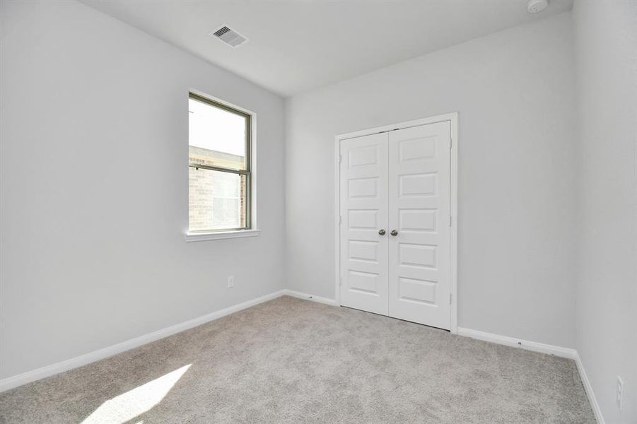 Generously sized secondary bedrooms featuring spacious closets, soft and inviting carpeting underfoot and large windows allowing plenty of natural light.