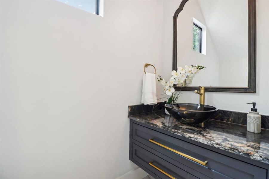 Beautiful modern detailing in the powder bath provide an impressive setting for your guests.