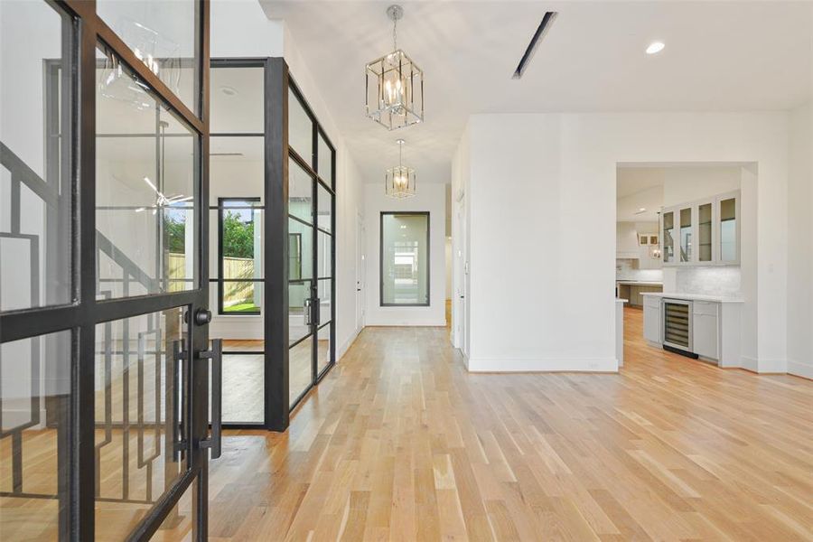 Elegance awaits as you enter and see the glass corner walls of the study overlooking the Lanai and courtyard. To the right is the formal dining room and butler's pantry with wine refrigerator, sink and space for an ice maker.