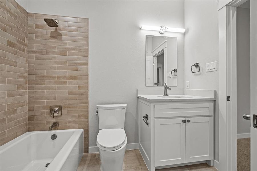 Full bathroom featuring tiled shower / bath, vanity, and toilet ensuite