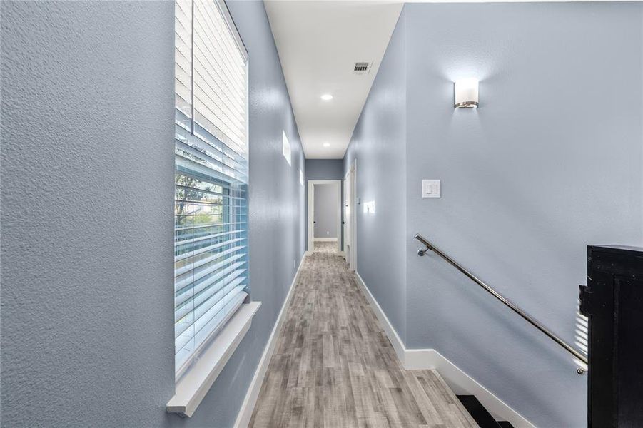 Hallway with light wood-type flooring