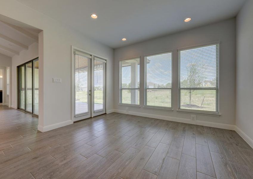 Breakfast area with large windows, creating a bright open space that peers into the back yard.