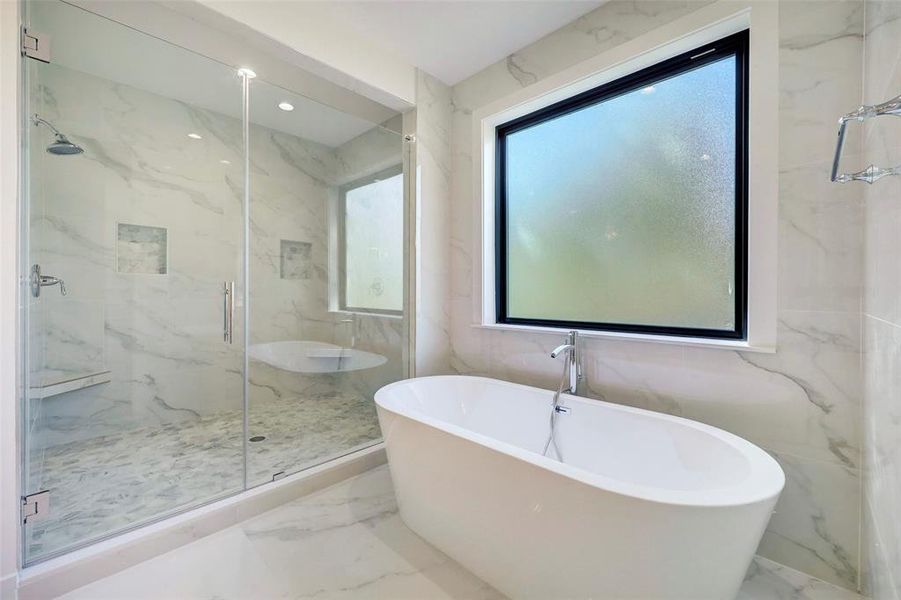 SAMPLE - Freestanding soaking tub and very large, seamless glass enclosed shower.