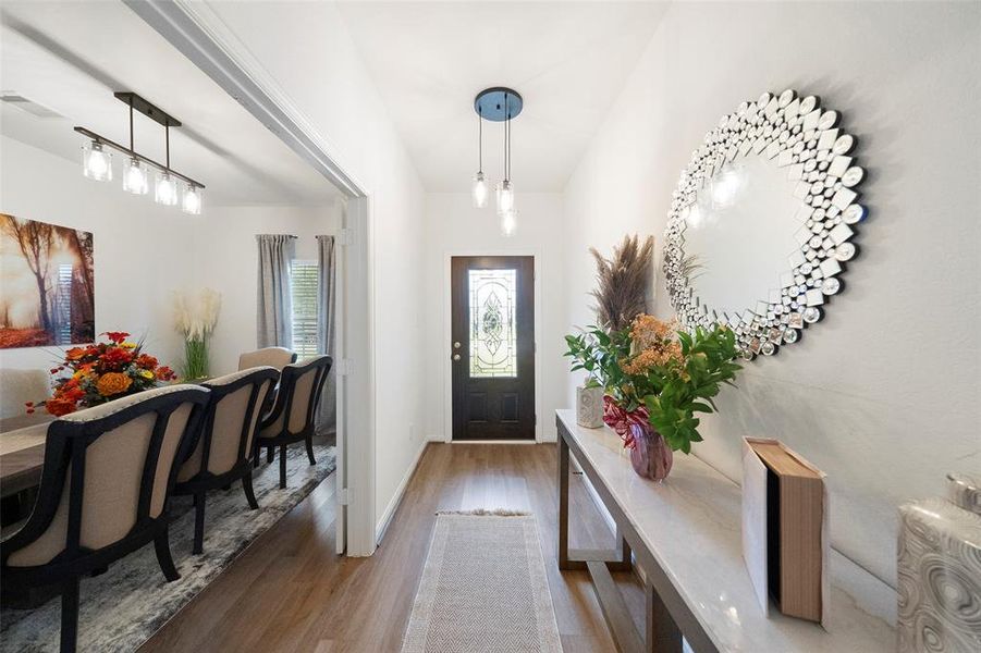 Beautiful and welcoming entry way with a glass in-lay door that lets in natural light.  Love the upgraded lighting in this entry way.