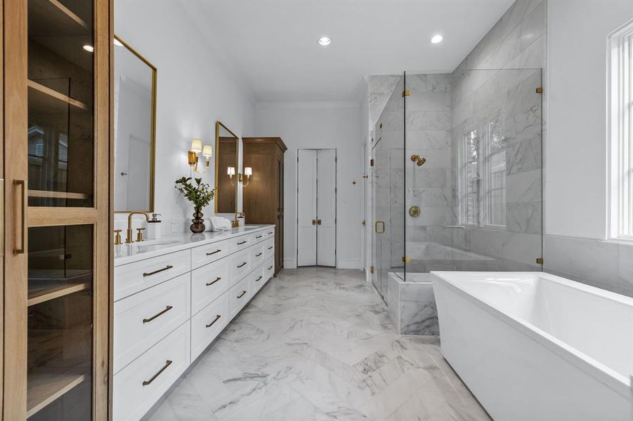 Bathroom featuring tile floors, shower with separate bathtub, and double sink vanity