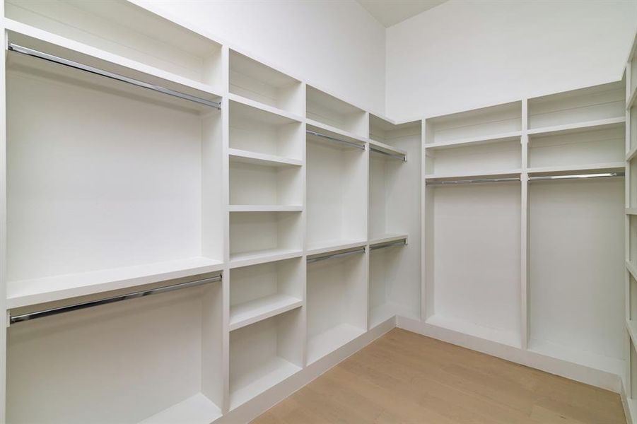 Spacious closet featuring light hardwood / wood-style floors