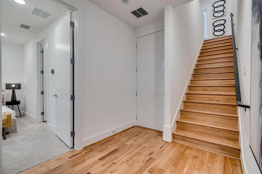 Stairs featuring hardwood / wood-style floors