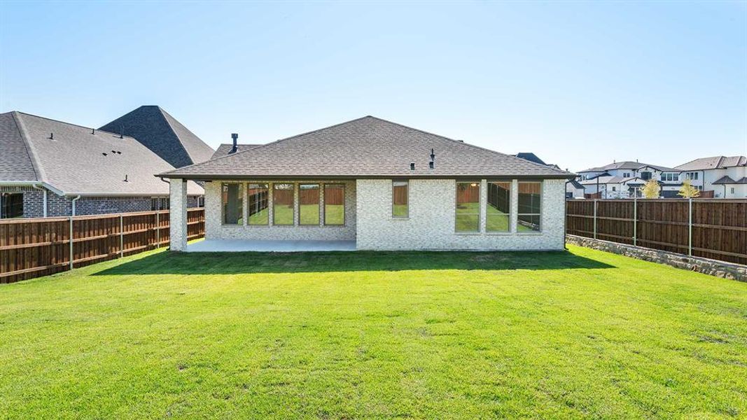 Back of house with a yard and a patio area