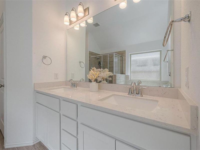 This bathroom is designed for convenience with its double sinks and ample counter space.