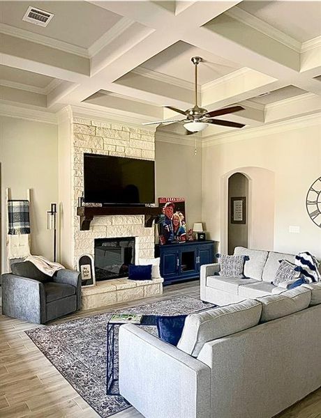 Living room with crown molding, hardwood / wood-style flooring, and coffered ceiling