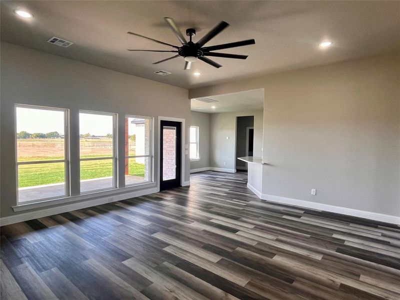 Spare room featuring ceiling fan and dark wood-type flooring