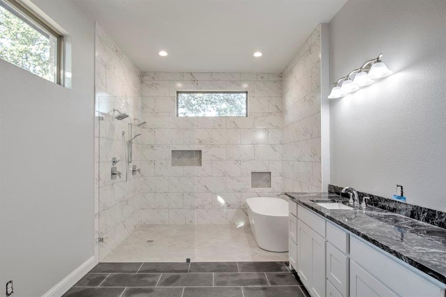 Bathroom with vanity, shower with separate bathtub, tile patterned flooring, and a wealth of natural light