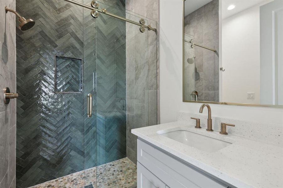 Bathroom featuring vanity and a shower