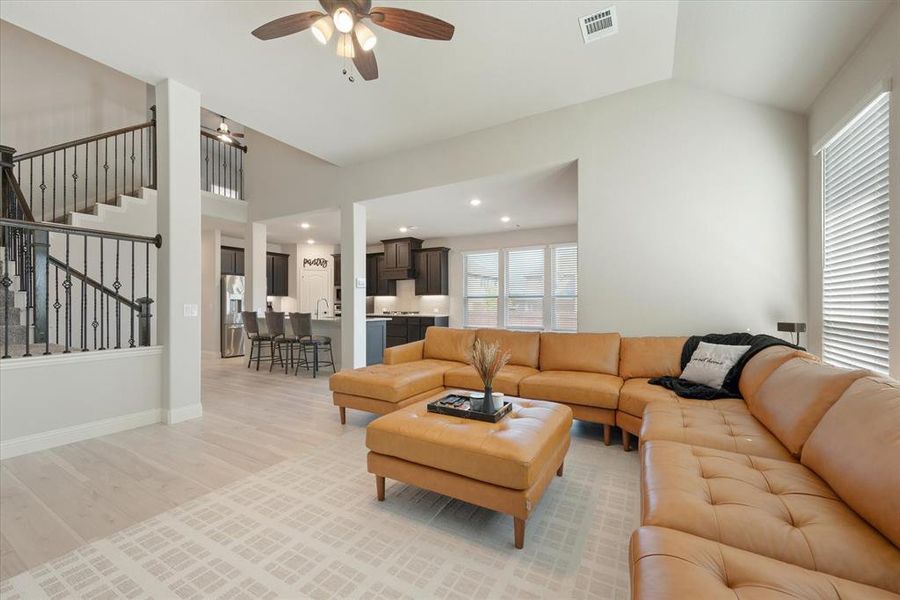 Fabulous open floor plan! Iron baluster staircase leads to game and media rooms and secondary bedrooms.