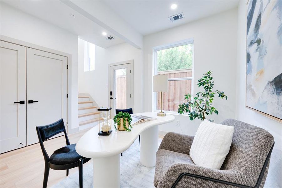 Living area featuring beam ceiling and light wood-type flooring