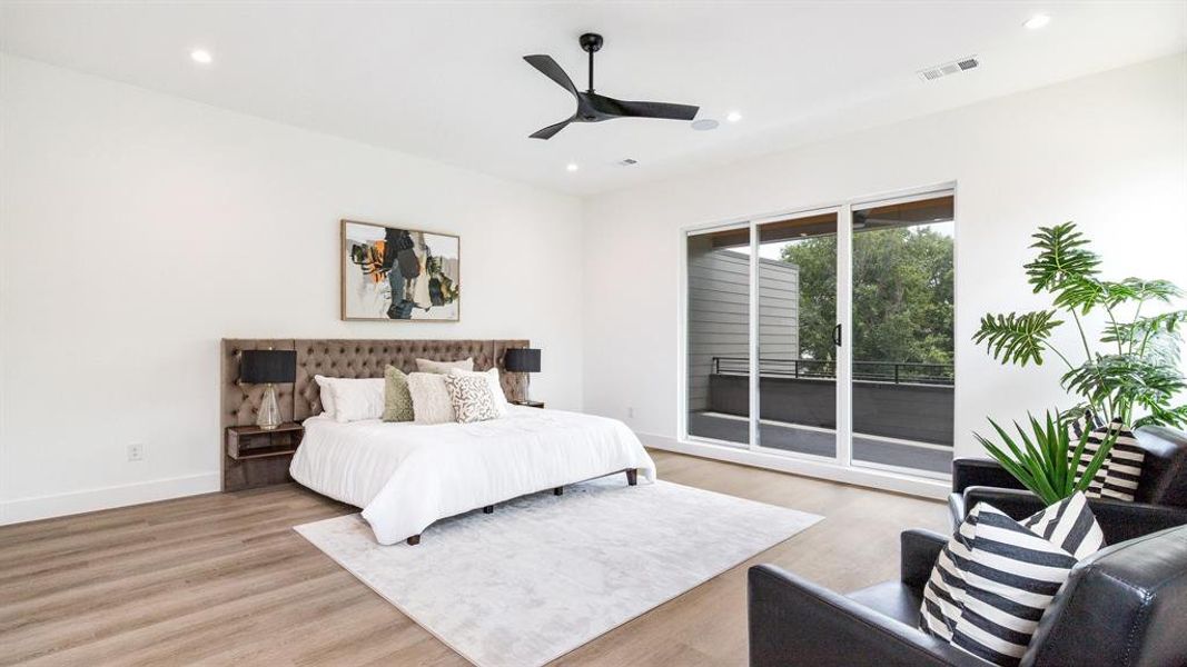 Bedroom featuring ceiling fan, light hardwood / wood-style floors, and access to outside