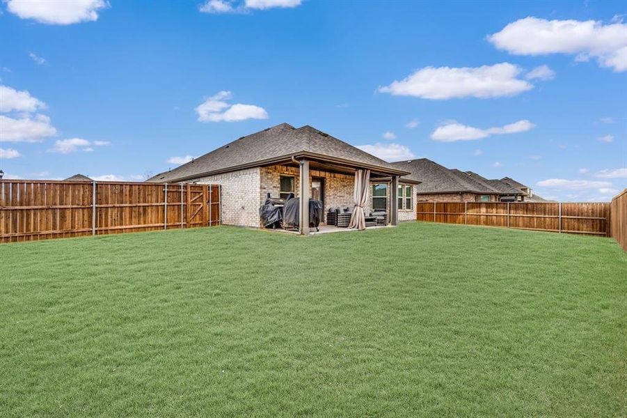 Back of house featuring a patio and a lawn