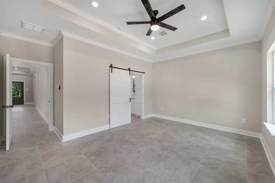 Master bedroom has tray ceiling,tile flooring, farm house door leading to private master bath room, and pre-wired for cable