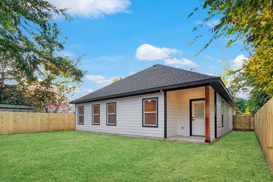 Rear view of property featuring a yard