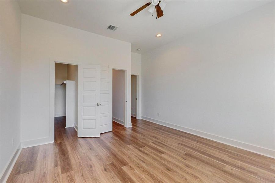 Unfurnished bedroom featuring ceiling fan and light hardwood / wood-style flooring